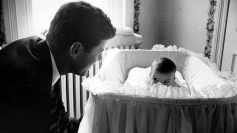 Sen. John F. Kennedy plays peekaboo with his 1-year-old daughter, Caroline, in 1958. He became President of the United States in 1961.