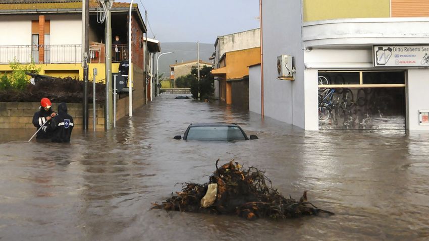 Rescuers work in a flooded street in the small town of Uras, Sardinia, Monday, Nov. 18, 2013. A violent rainstorm that flooded entire parts of the Mediterranean island of Sardinia has led to the deaths of at least nine people. Bridges were felled by swollen rivers and water levels reached 3 metres (yards) in some places. 
