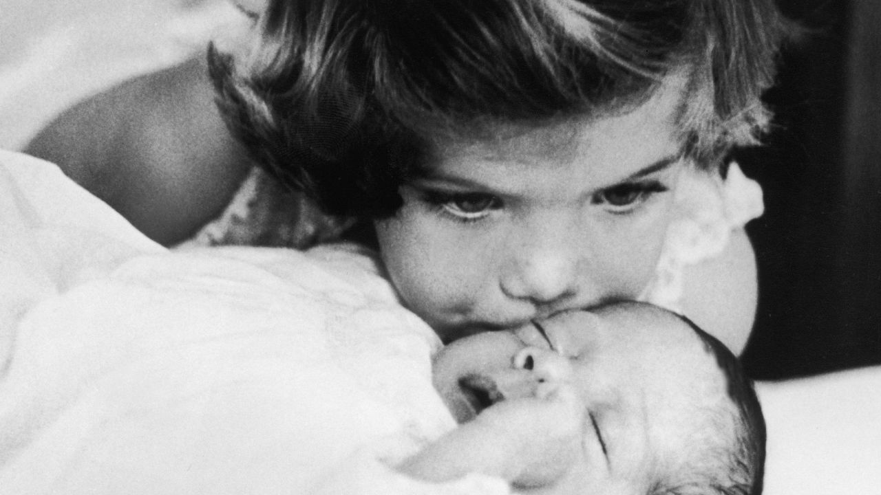Caroline kisses her newborn brother, John Kennedy Jr., in 1961.