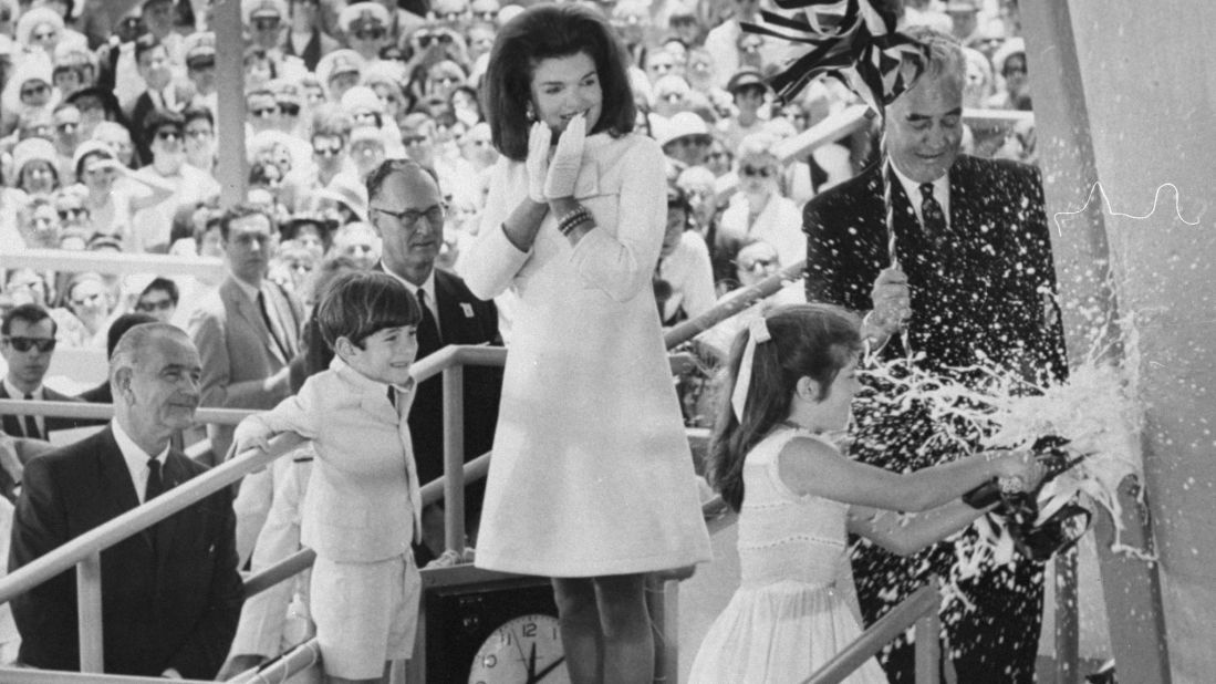 Caroline breaks a bottle of champagne on the bow of the USS John F. Kennedy during the aircraft carrier's christening in 1967.