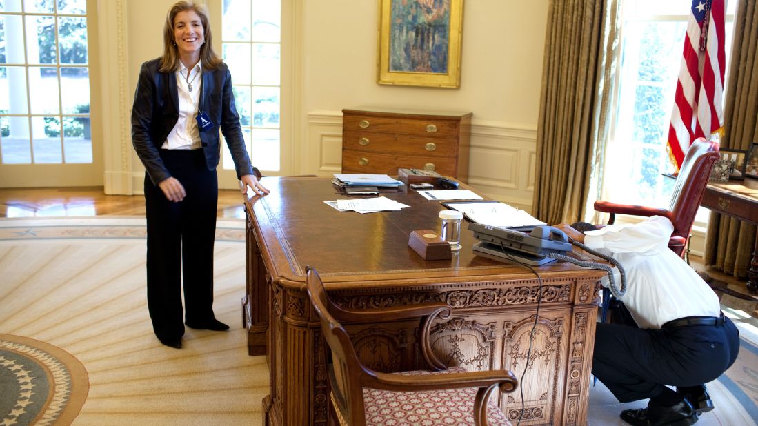 President Barack Obama examines his Oval Office desk while visiting with Kennedy in 2009. Obama was recalling the <a href="http://www.whitehousemuseum.org/furnishings/resolute-desk.htm" target="_blank" target="_blank">famous photograph</a> of Kennedy's brother peeking through the desk.