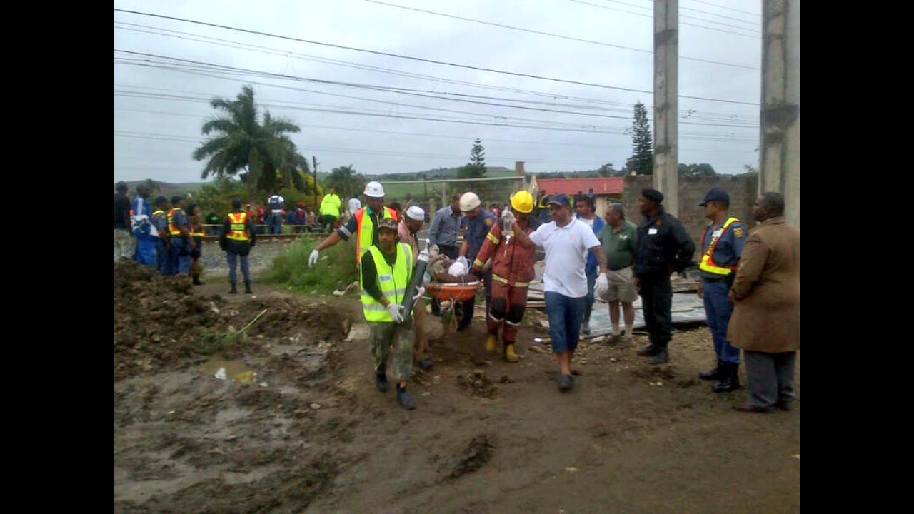 Medical personnel carry an injured person from the site of the collapse.