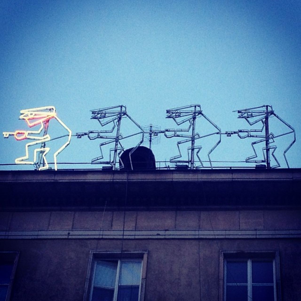 A neon sign on the roof of a building as captured by the Instagramers Wroclaw collective.