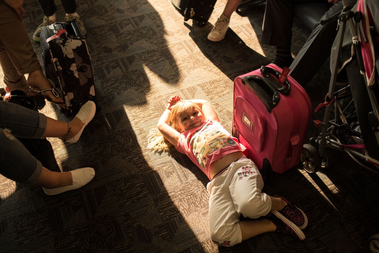 Shannon Nevin, 4, waits with her family at gate A21 for a flight to Savannah, Georgia.