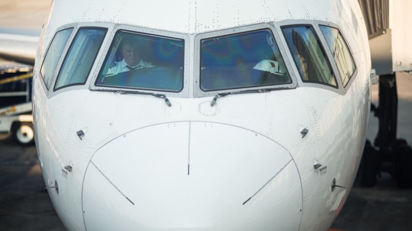 Delta pilots sit in the cockpit of a plane on Concourse A of the Atlanta airport.