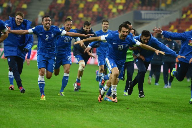 Greece's footballers provide some light relief for their compatriots when drawing 1-1 in Romania to reach the World Cup as convincing 4-2 aggregate winners. 