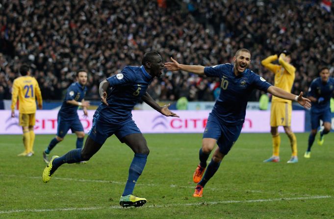 Mamadou Sakho and Karim Benzema celebrate as Ukraine score a late own goal to give France a 3-2 aggregate lead and a place in the European history books. 