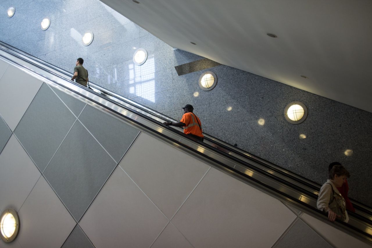 People ride an escalator near Concourse E.