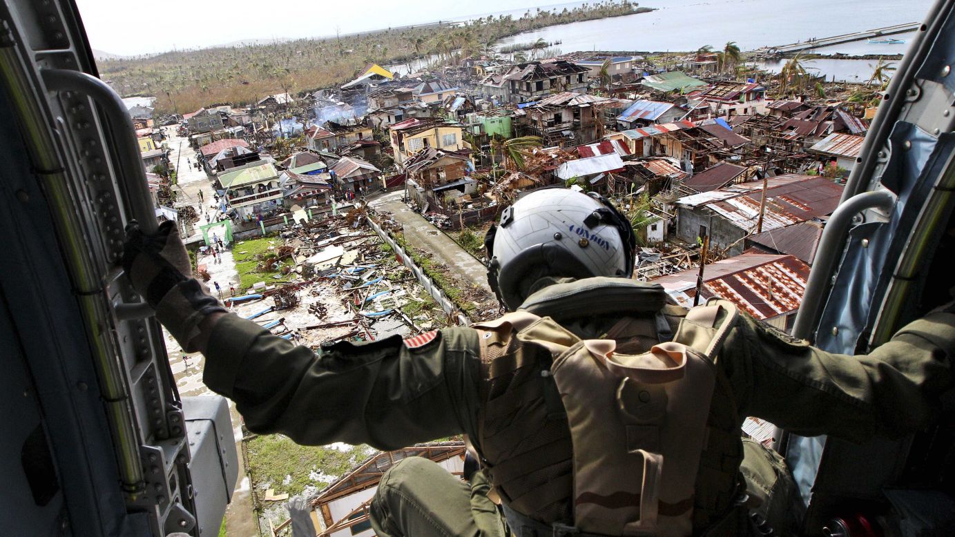 A crew member aboard a U.S. Navy helicopter looks out over Lawan, Philippines, before dropping relief goods November 20. 