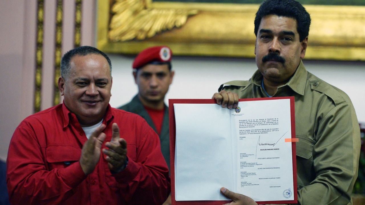 The president of the Venezuelan National Assembly, Diosdado Cabello, applauds Wednesday as Venezuelan President Nicolas Maduro shows the document giving him special decree powers.