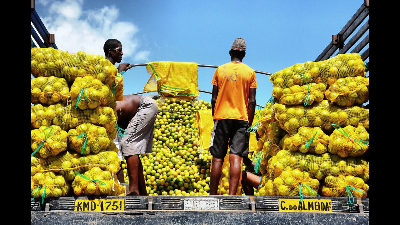 These men are preparing to sell oranges at the São Joaquim Market in Salvador, Brazil.