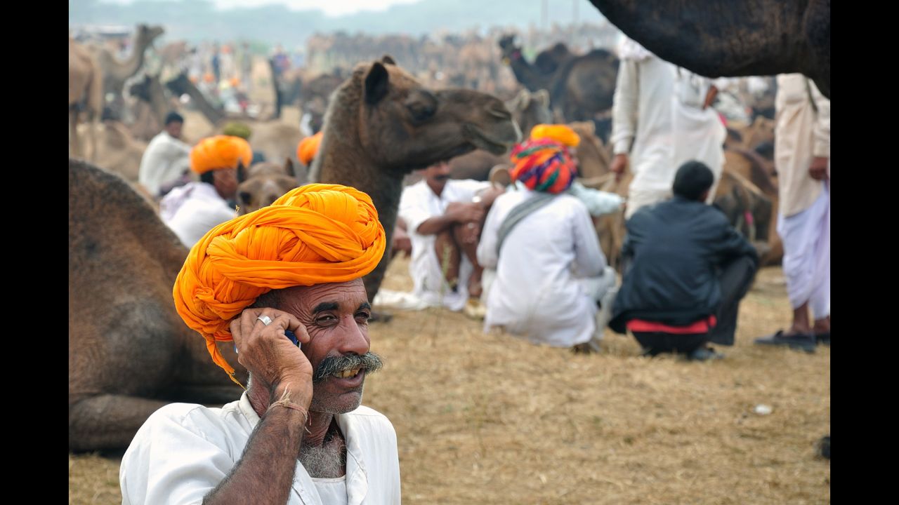 This Indian man received a loan that allowed him to buy and trade camels at the Pushkar Fair in Rajasthan, India.