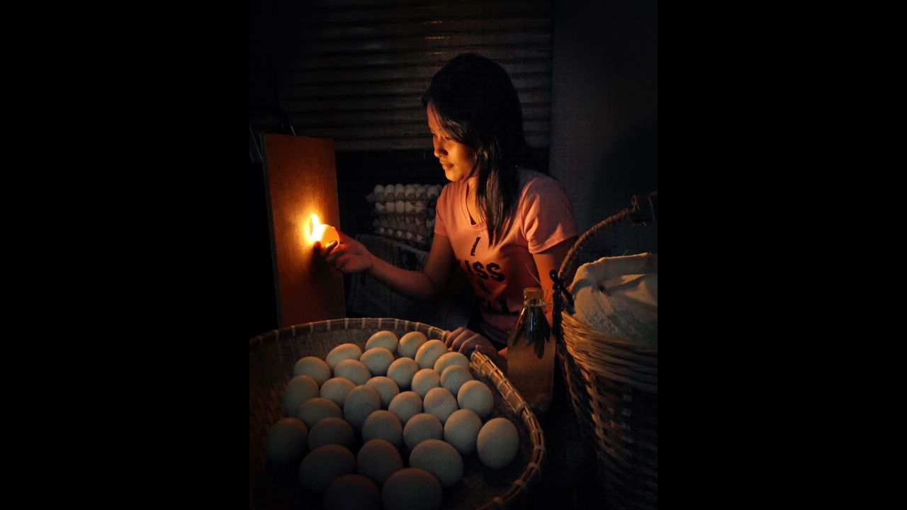 A vendor sorts duck eggs that have been fertilized or are developing duck embryos to be cooked. The eggs are then used in popular foods that are sold as street food.  