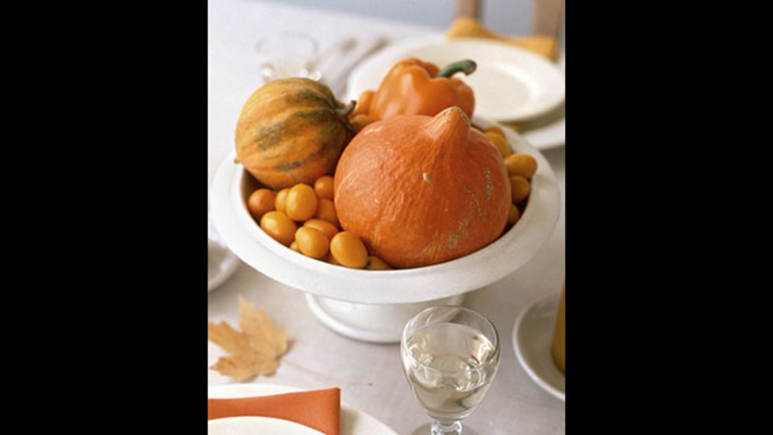 Autumn centerpiece: Orange fruits and vegetables make up this market-fresh centerpiece.