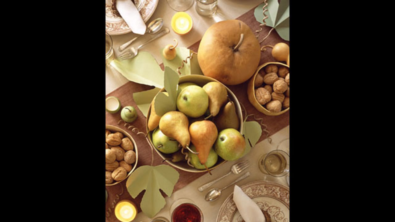 Harvest table: This centerpiece is <a href="http://www.marthastewart.com/264215/setting-a-thanksgiving-table" target="_blank" target="_blank">grounded by hollowed-out gourds</a>.