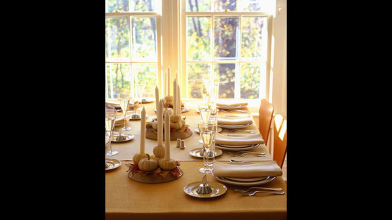 Tableau decorations: <a href="http://www.marthastewart.com/265672/thanksgiving-table-tableau-decorations?xsc=synd_cnn" target="_blank" target="_blank">Make your own</a> mini pumpkin candle holders.