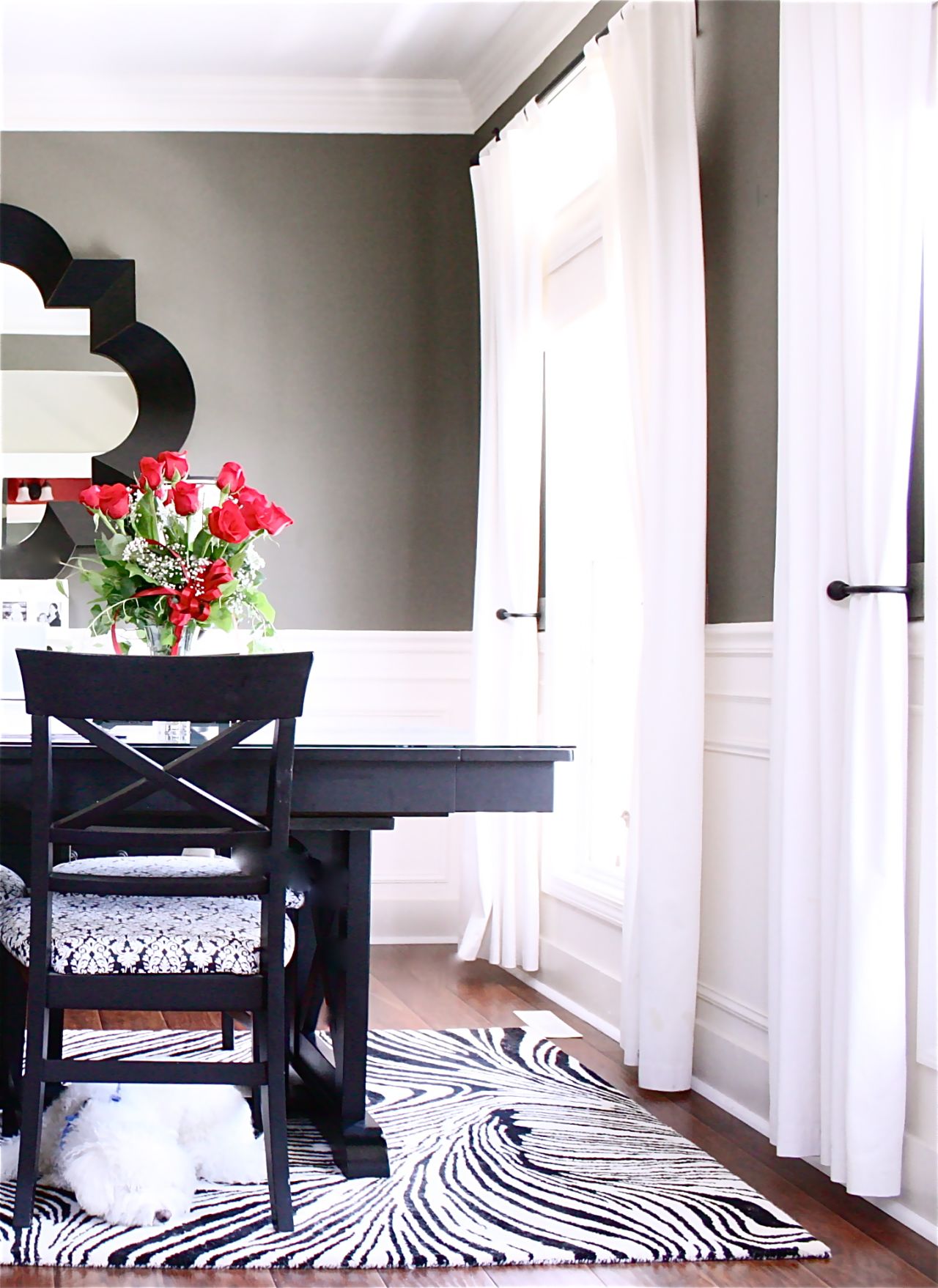 "<a href="http://www.theyellowcapecod.com/2012/08/my-home-office-dining-room.html" target="_blank" target="_blank">The Yellow Cape Cod</a>" blogger and stylist Sarah Macklem used dark colors and reflective surfaces in her dining room, which doubles as a home office.