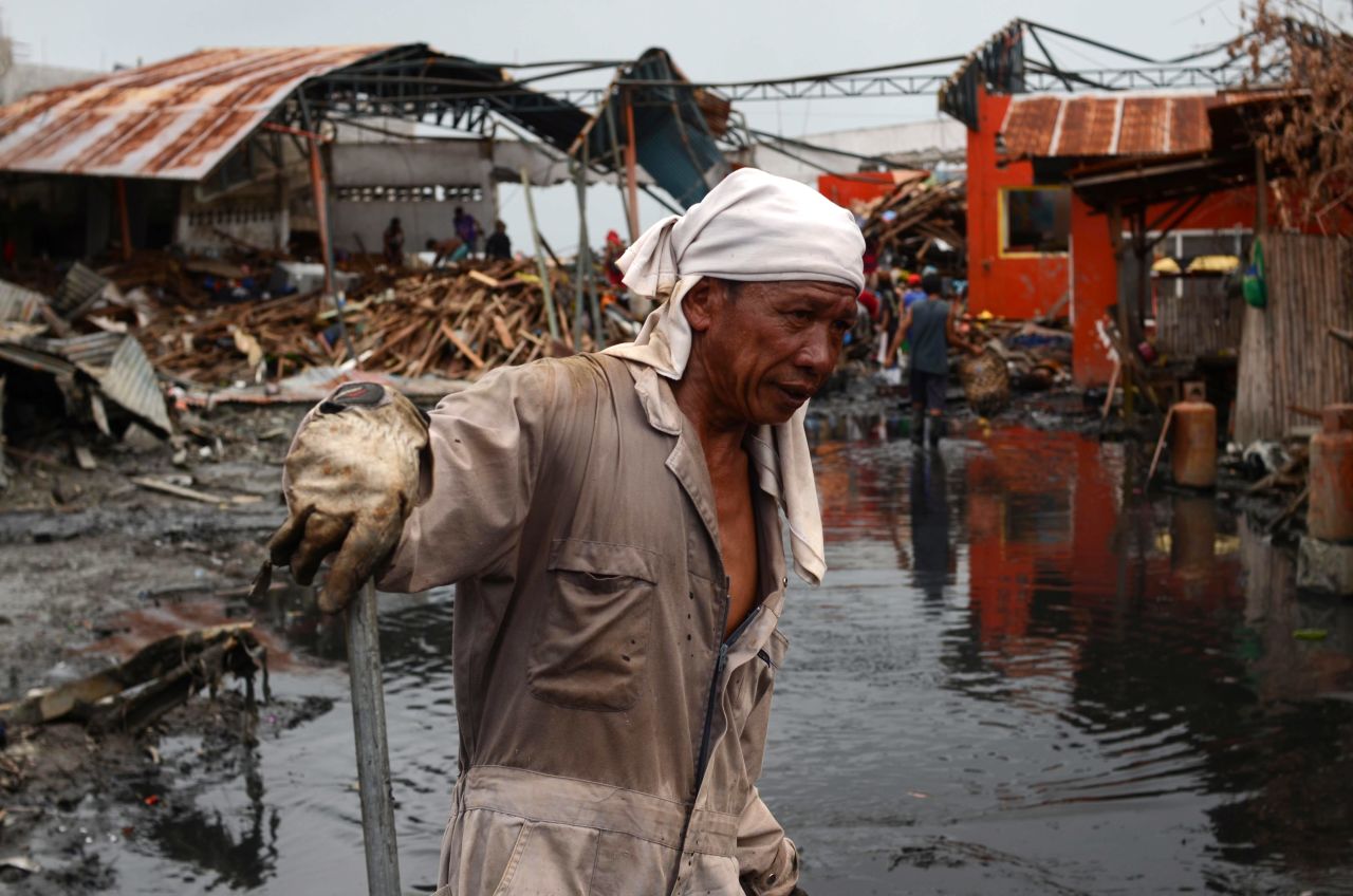 Workers clear mud and debris in Tacloban on November 20.
