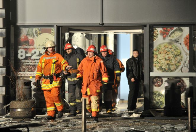 Rescuers work at the Maxima grocery store.