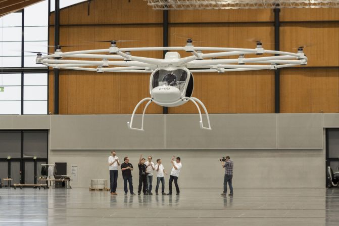 German engineers celebrate as the Volocopter, one of the world's first electric helicopters, takes off on its maiden flight.