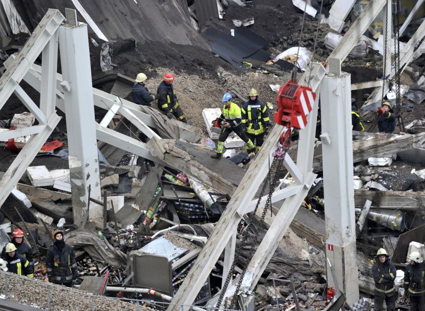 Rescue workers search through the debris of the Maxima supermarket in Riga on November 22.