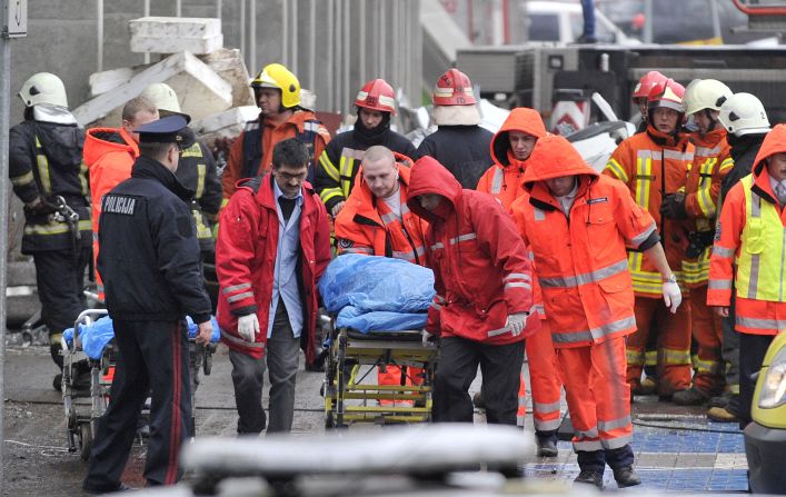 Rescue workers carry a victim on a stretcher outside the market on November 22.