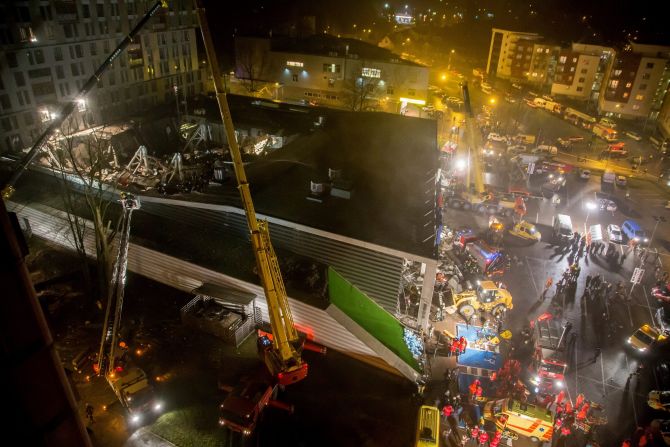Rescue workers search through the rubble for victims at the supermarket on November 21.