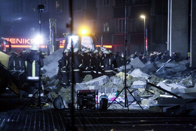 Rescue workers outside the Maxima supermarket after the roof collapse on November 21.