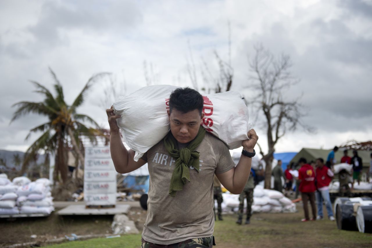 A Philippine Air Force crew member loads aid onto a helicopter at the airport in Tacloban, Philippines, on Friday, November 22. 