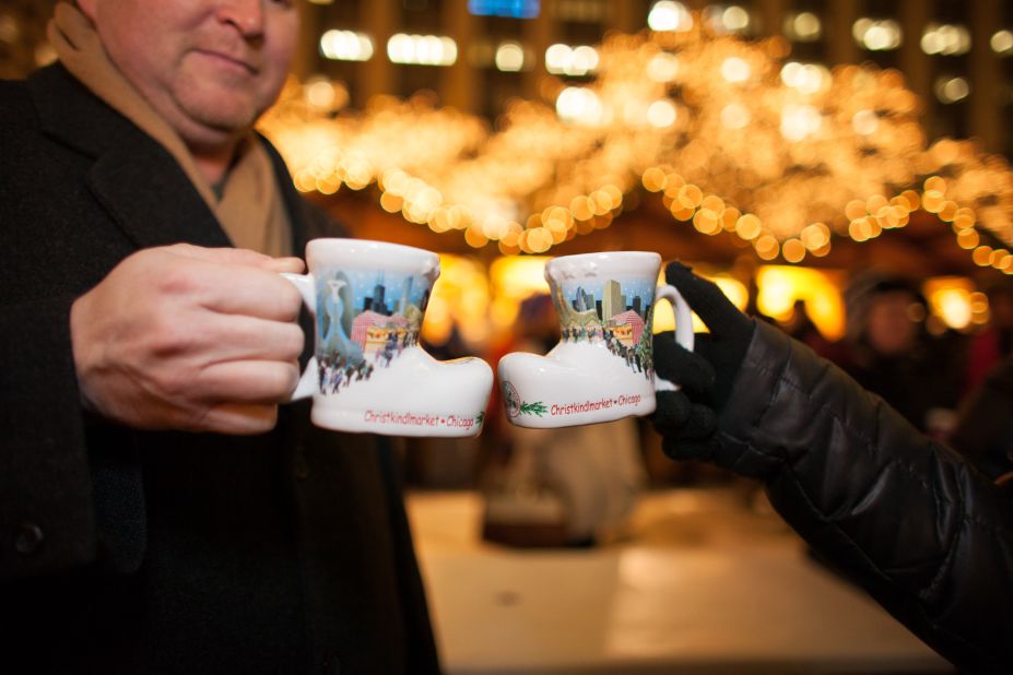 Revelers clink commemorative mugs at Chicago's Christmas market.
