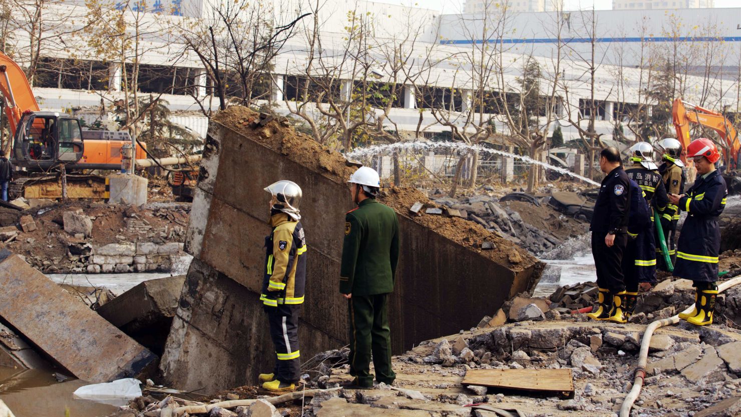 Chinese rescuers search for victims after an oil pipeline exploded in Qingdao on November 22.