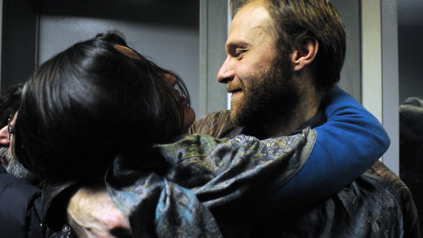 Photographer Denis Sinyakov, one of the 'Arctic 30,' hugs his wife Alina as he is released on bail on November 21 in Russia.