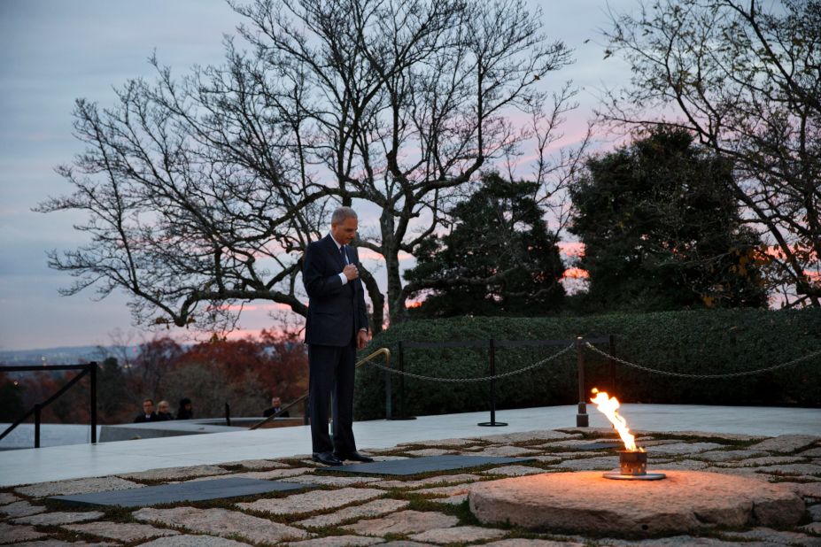 Attorney General Eric Holder pays his respects at Kennedy's grave on November 22. Holder has been visiting the grave since his youth, and he used to come with his mother before she passed away.