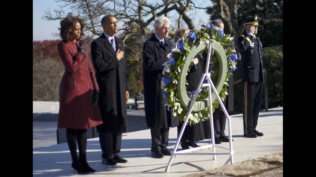 First lady Michelle Obama, President Obama, former President Bill Clinton and former Secretary of State Hillary Clinton pause during a wreath-laying ceremony Wednesday, November 20, at Arlington National Cemetery.