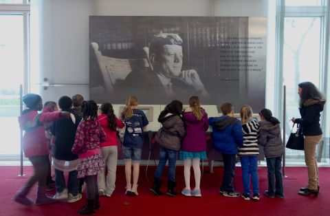 On the 50th anniversary of John F. Kennedy's death, children gather around a multimedia display Friday, November 22, in the grand foyer of the John F. Kennedy Center for the Performing Arts in Washington.