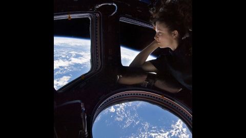 A throwback to 2010 for the International Space Station's 15th anniversary: NASA astronaut Tracy Caldwell Dyson looks down at Earth through a window on the ISS. 