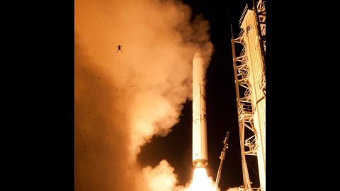 There it goes! A still camera on a sound trigger captured this intriguing photo of an airborne frog in the foreground as NASA's  Lunar Atmosphere and Dust Environment Explorer spacecraft lifts off toward the moon. This <a href=