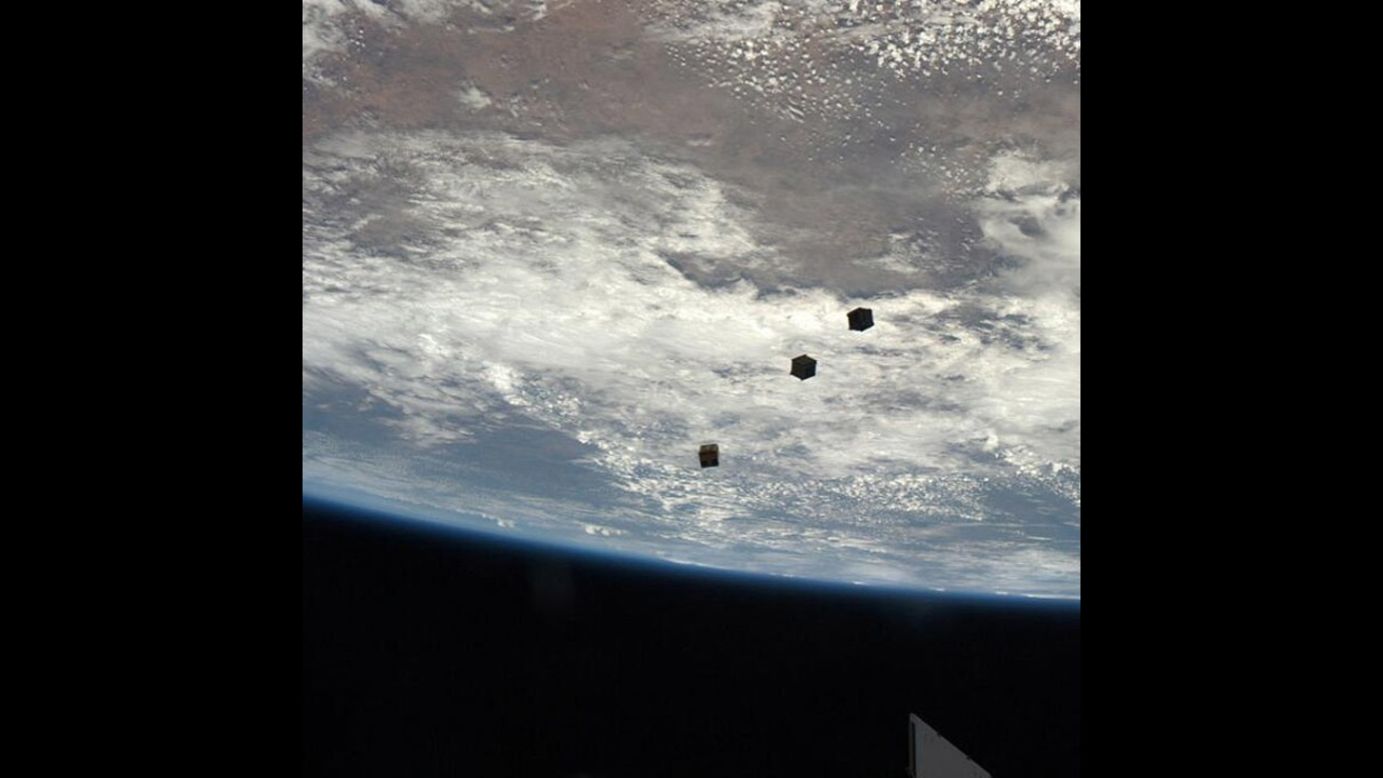 Drifting away: three nanosatellites, known as Cubesats, are deployed from the ISS airlock. 