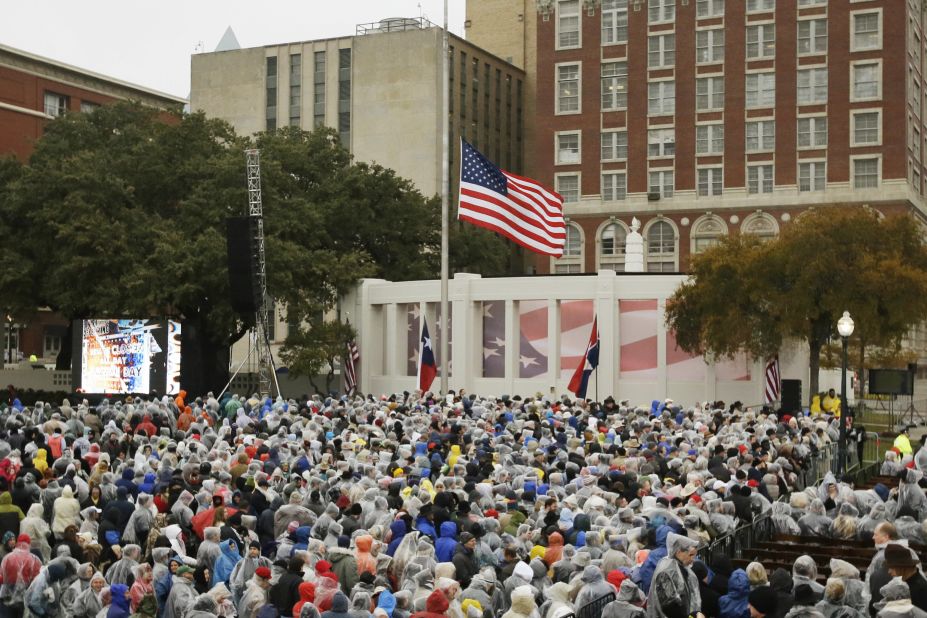 People gather at Dealey Plaza on November 22. "A new era dawned and another waned a half century ago when hope and hatred collided right here in Dallas," Rawlings said in his remarks.