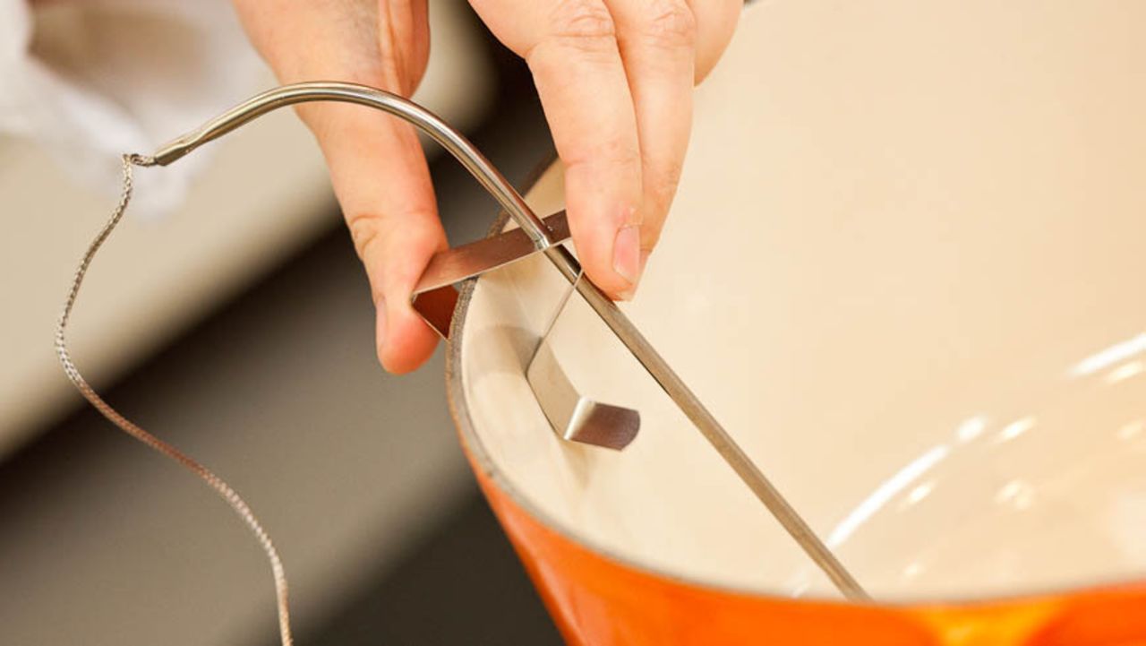 To monitor the oil temperature, it's best to use a thermometer that clips to the side of the pot.