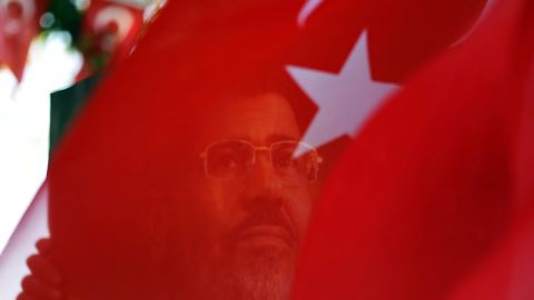 A portrait of ousted Egyptian president Mohamed Morsy is seen through a Turkish flag during a rally in Istanbul. 