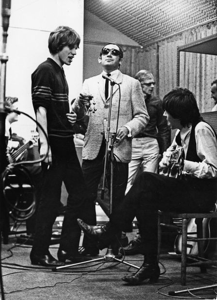 Jagger, Richards and Oldham (background) in the studio with Lionel Bart, songwriter, pop impresario, and composer of the hit musical <em>Oliver!</em>