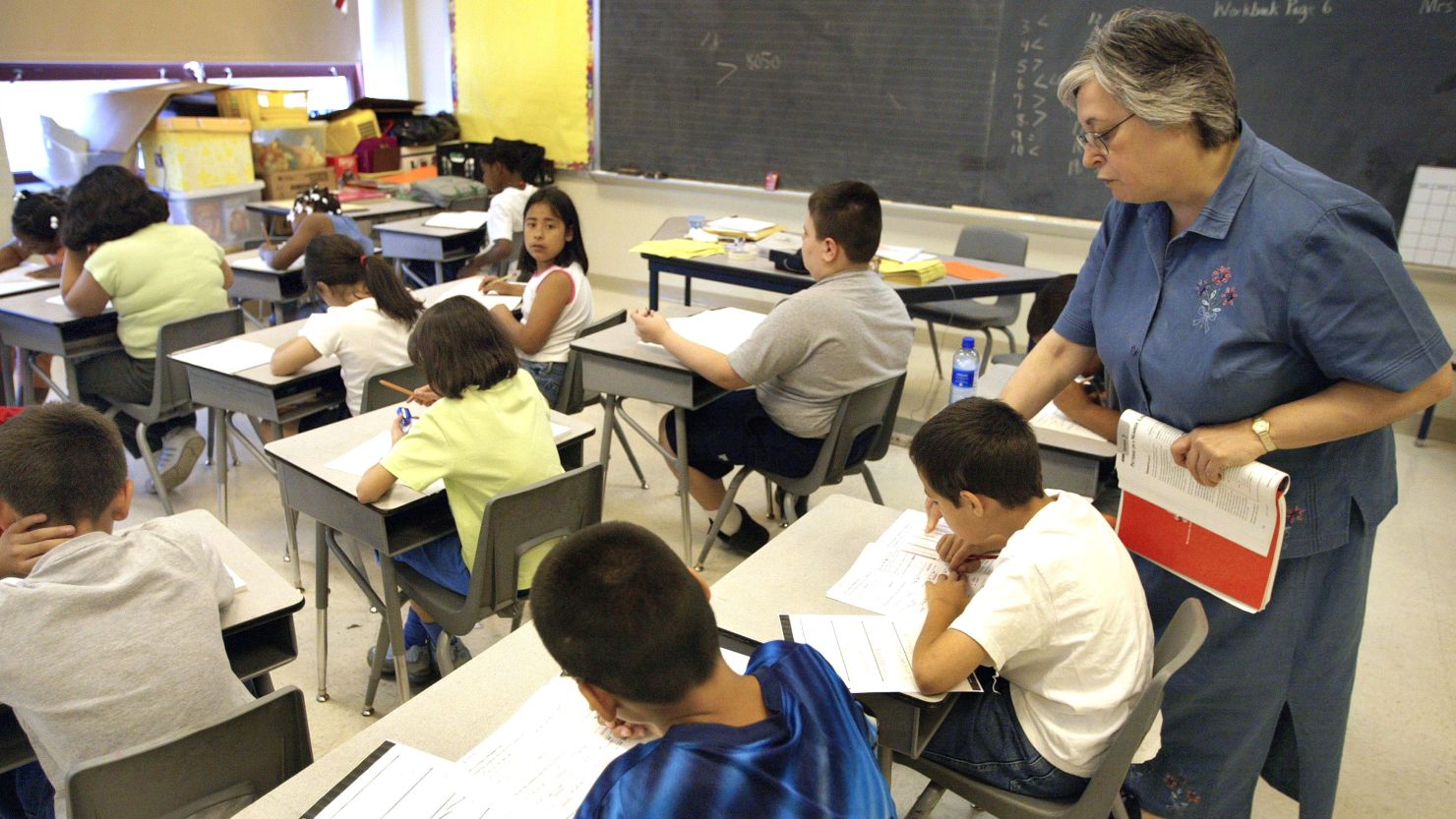 A teacher assists third-grade students in a Chicago classroom. 