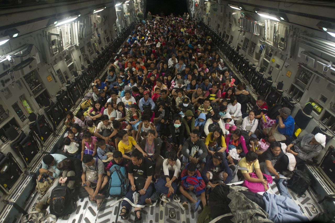 Approximately 400 Tacloban residents displaced by Typhoon Haiyan fill the cargo hold of a C-17 Globemaster military cargo plane on  Friday, November 22, 2013. Joint Task Force 505 personnel are conducting search and rescue, supply drops and personnel airlifts as part of relief efforts.
