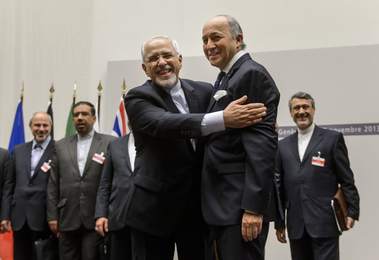 Iranian Foreign Minister Mohammad Javad Zarif, left, and French Foreign Minister Laurent Fabius react after the announcement. 