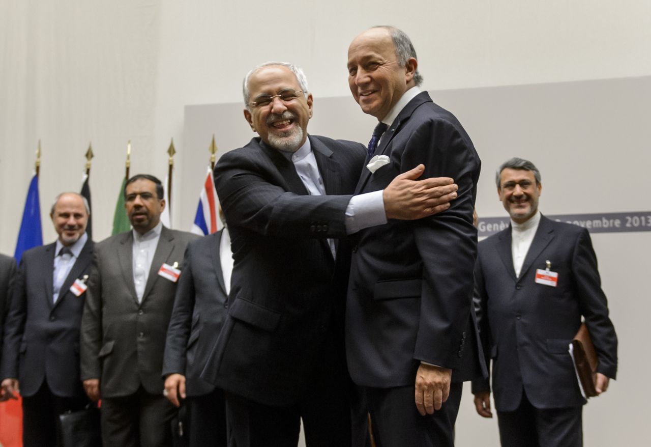 Iranian Foreign Minister Mohammad Javad Zarif, left, and French Foreign Minister Laurent Fabius react after the announcement.