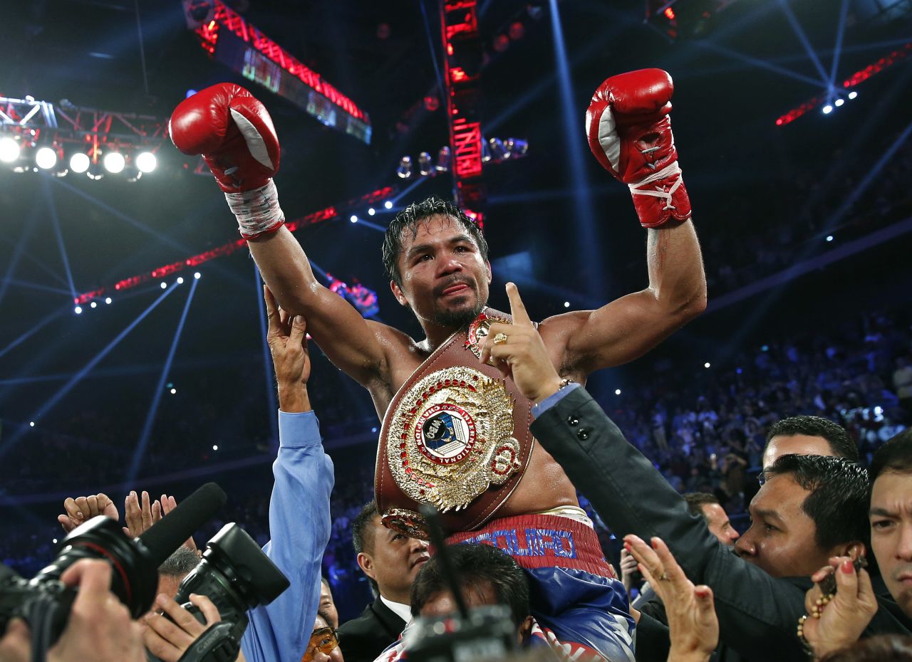 Manny Pacquiao wears the champion's belt after defeating Brandon Rios on Sunday, Nov. 24, 2013, in Macau.
