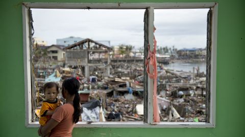 A woman looks over the devastated waterfront in Tacloban on November 24.