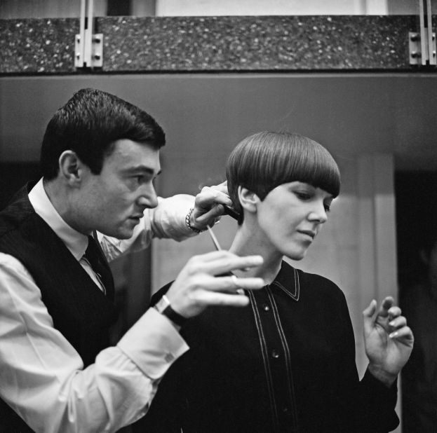 Legendary hairdresser Vidal Sassoon applies the finishing touches of his trademark "wedge bob cut" to miniskirt inventor Mary Quant. "I was walking down Bond Street and there was a picture of a haircut that knocked me sideways. I knew I wanted <em>my </em>hair cut like <em>that," </em>says Quant. 