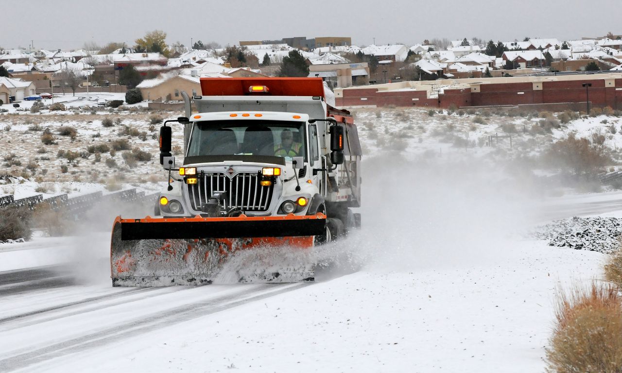 A plow and sanding truck heads up Paseo del Norte in Albuquerque, New Mexico, on Sunday, November 24.